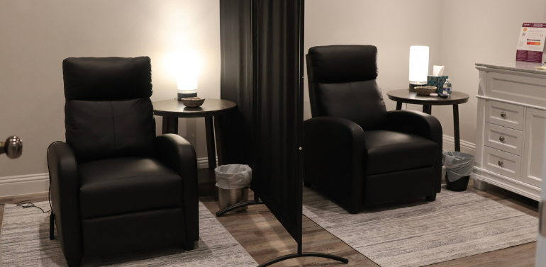 A serene and private treatment room designed for Spravato® (esketamine) therapy, featuring a comfortable reclining chair, soft lighting, and a calm atmosphere to ensure patient comfort and safety.